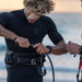 Kiteboarder attaching a North Standard short kite leash to a harness