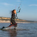 Kiteboarder riding flat water hooked in with a North short freeride leash