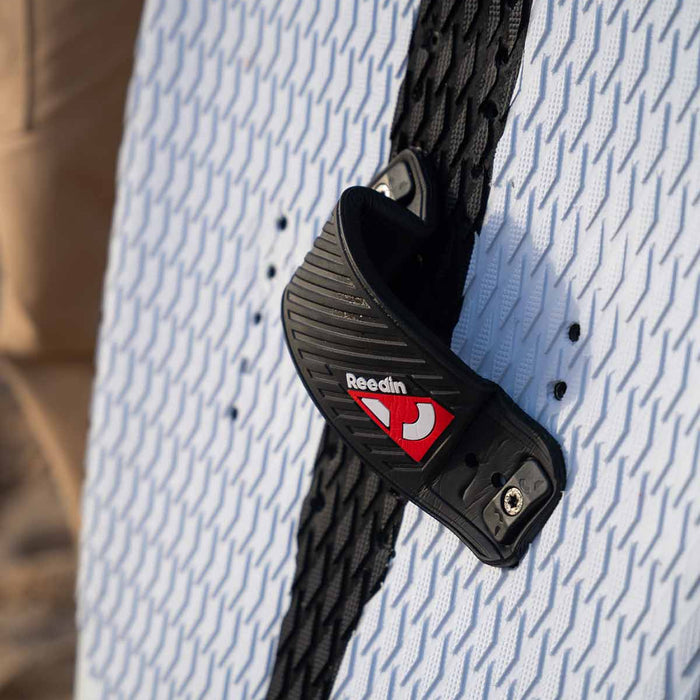 Close up of the the Reedin Layflat foot strap mounted on a Reedin Feather board