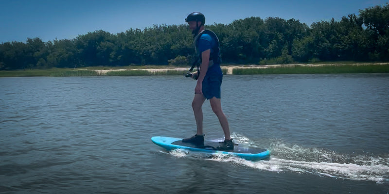 Guy riding an efoil board in flat water